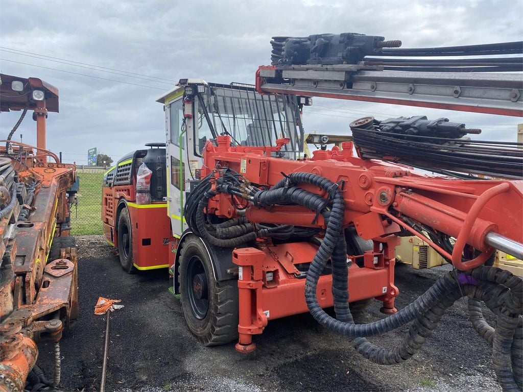 An orange Sandvik drill